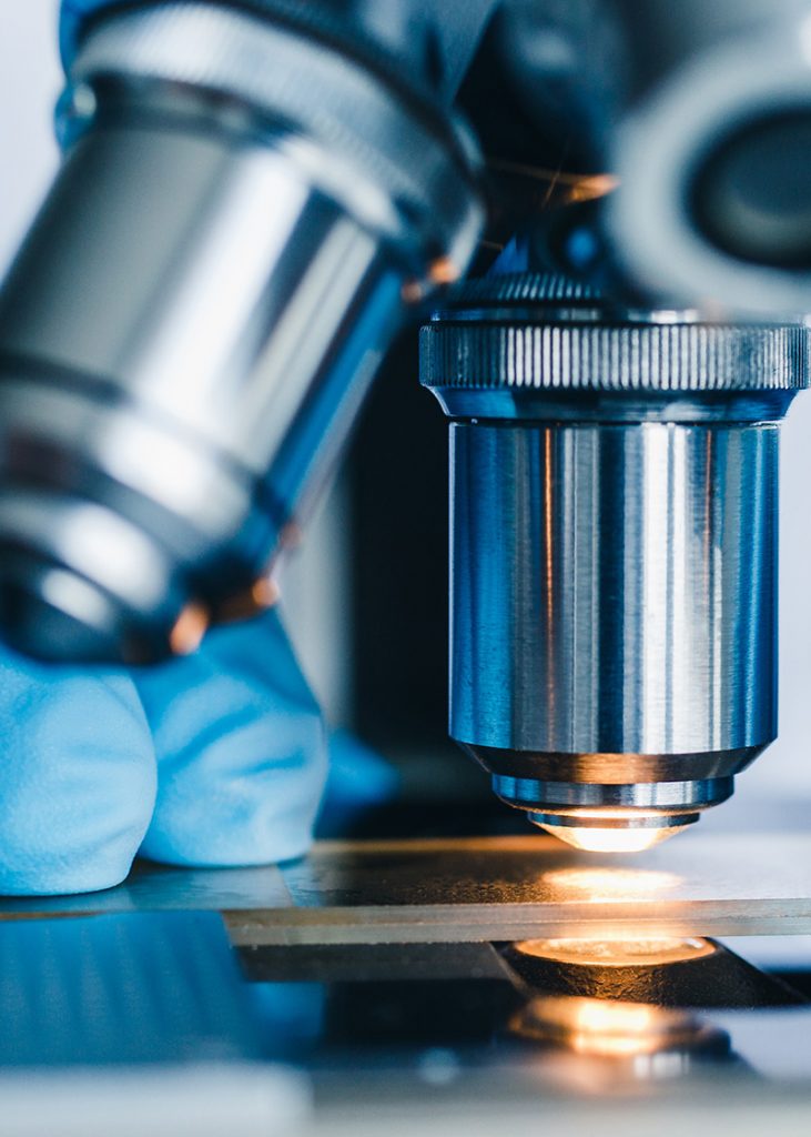 Close-up shot of microscope with metal lens at laboratory.