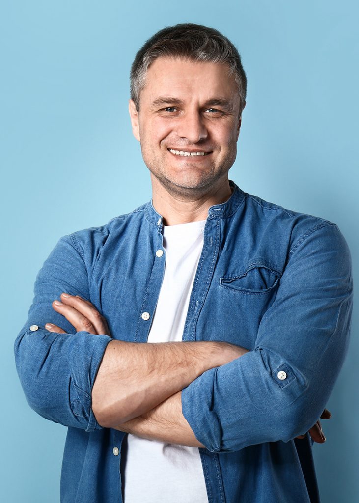 Portrait of handsome mature man on color background