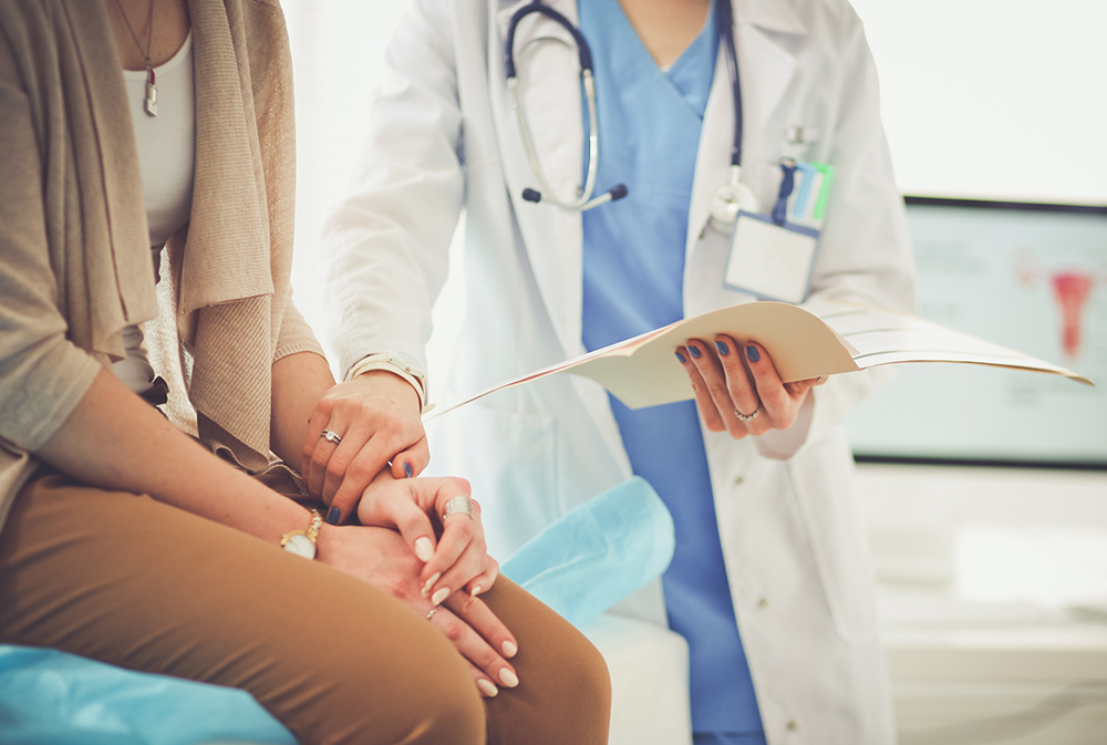 Doctor and patient discussing something while sitting at the table. Medicine and health care concept. Doctor and patient.